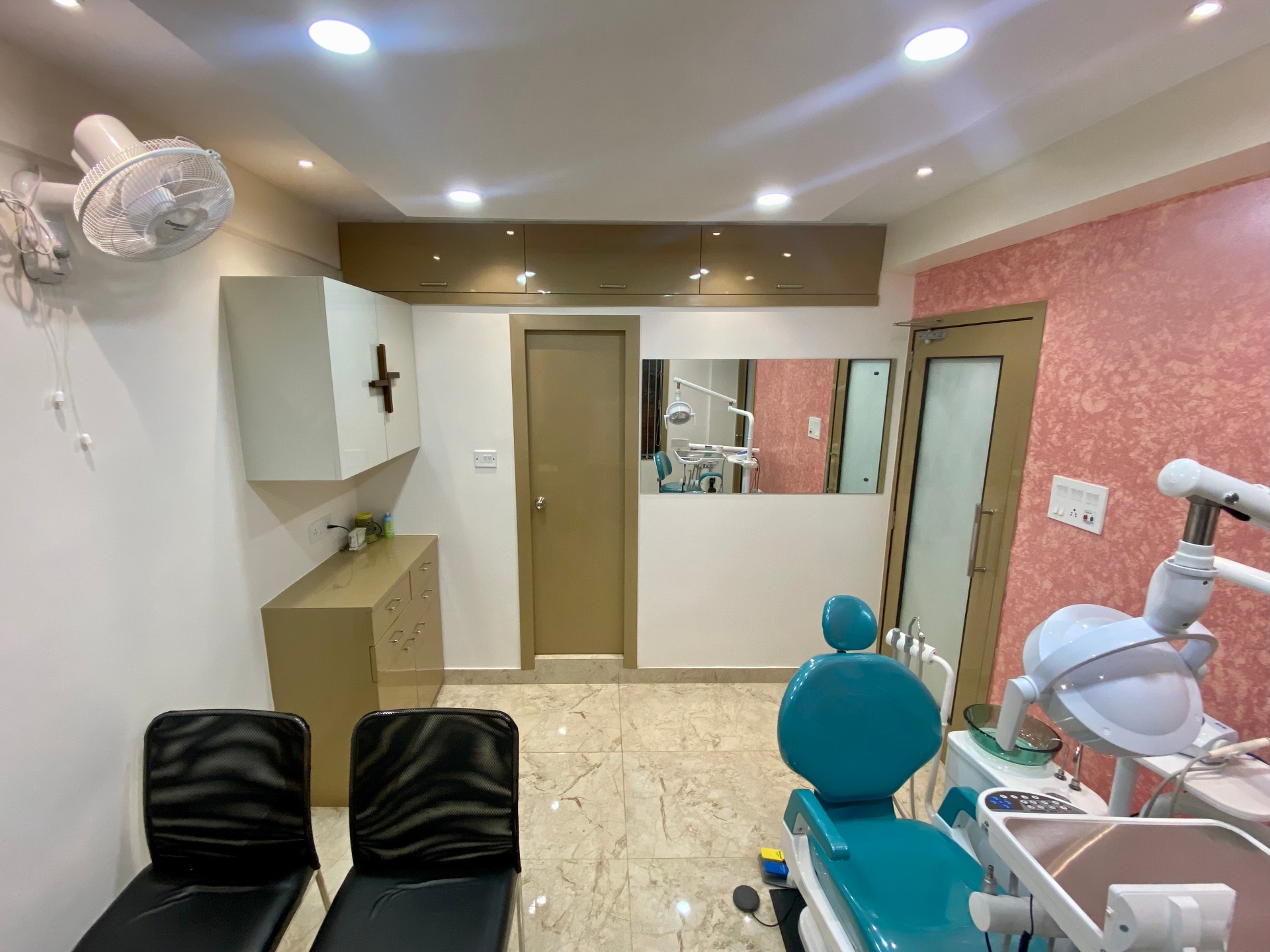 Dental chair against textured accent wall inside the OroCare Dental Clinic Mukundapur treatment room