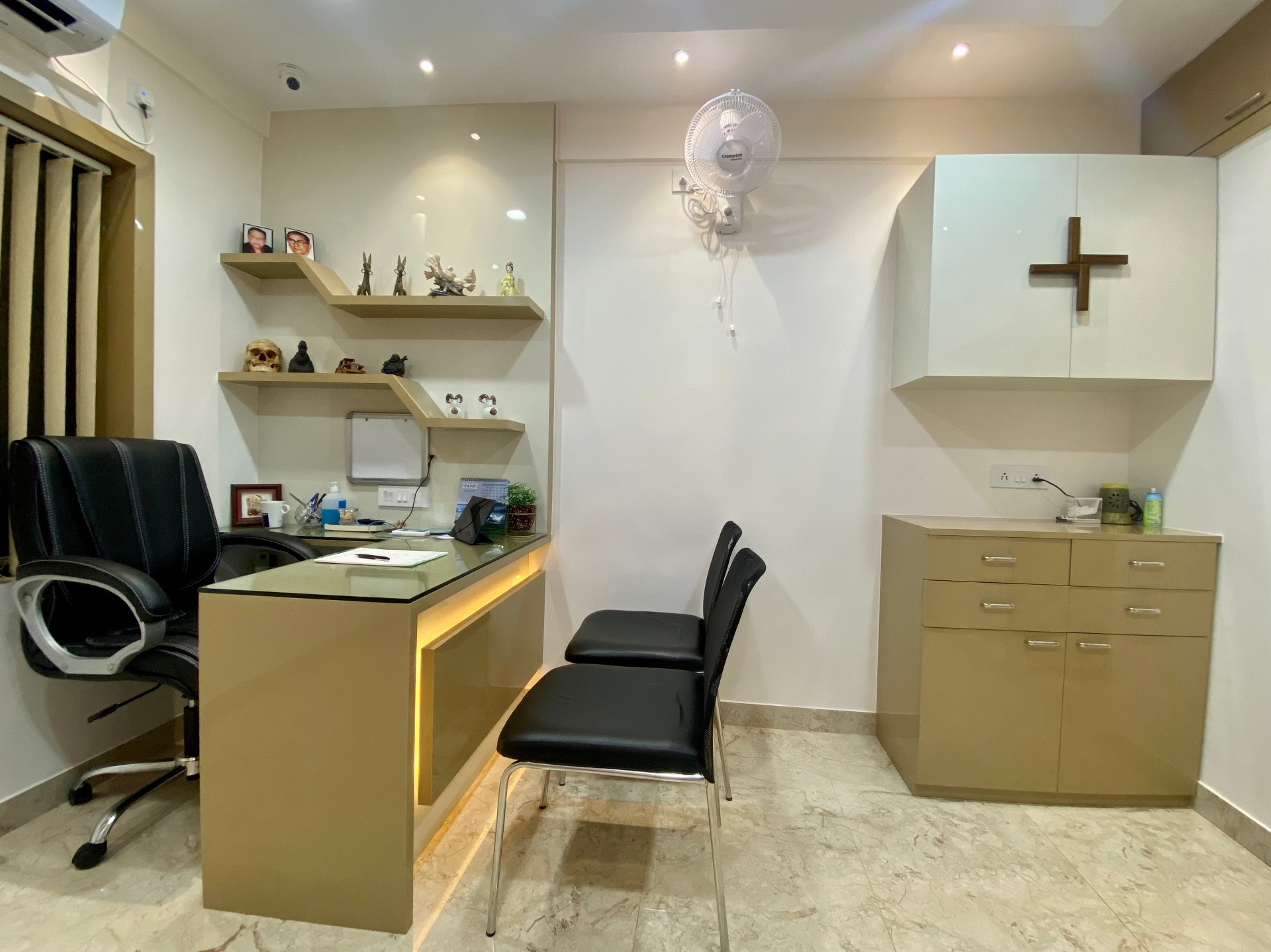 Doctor's consultation office with desk, patient chairs and cabinetry at OroCare Dental Clinic, Mukundapur