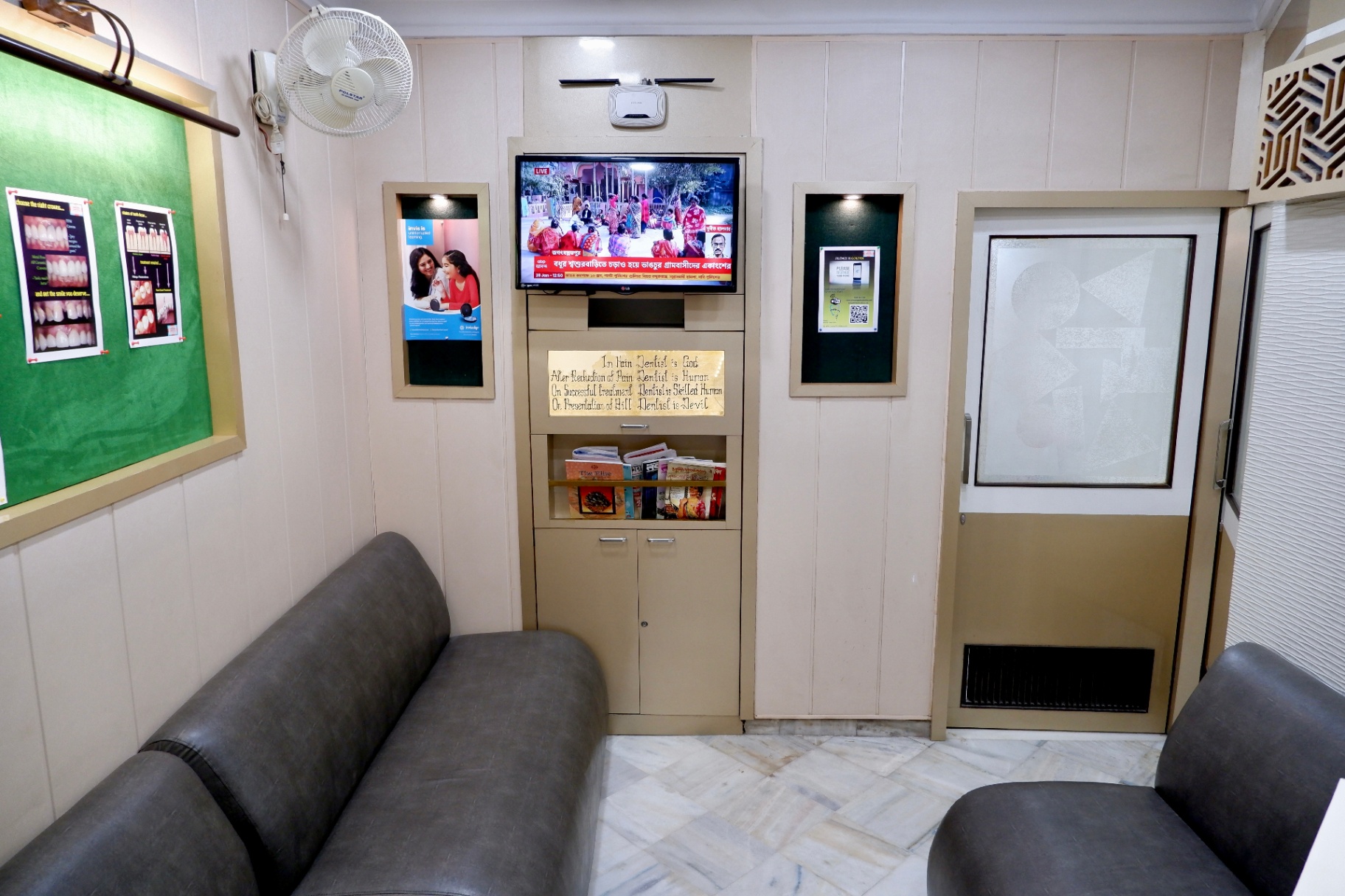 Patient waiting lounge with sofa seating and information TV at OroCare Dental Clinic, Bhowanipur