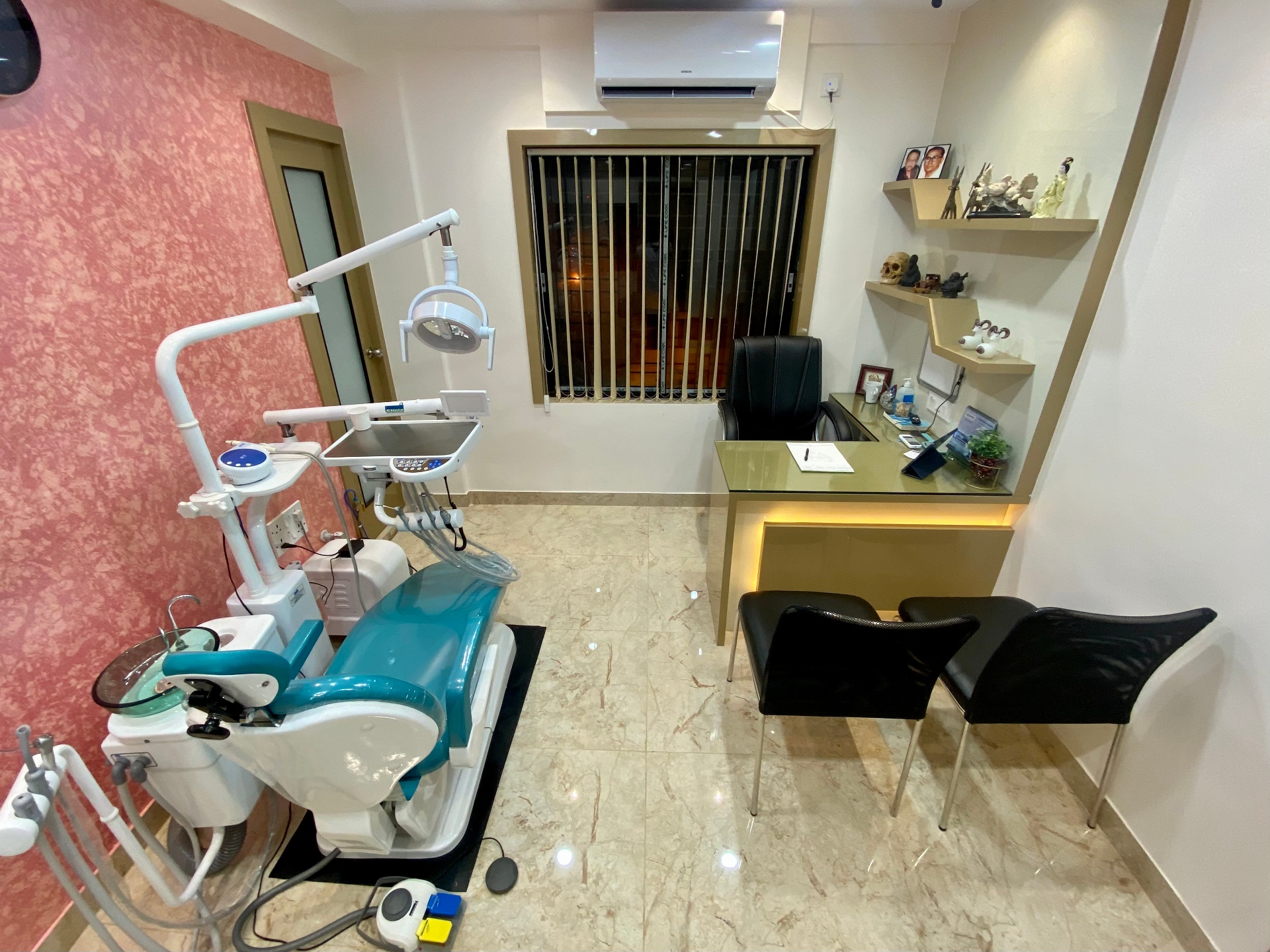 Consultation-cum-operatory room with dental chair beside the doctor's desk at OroCare Dental Clinic, Mukundapur